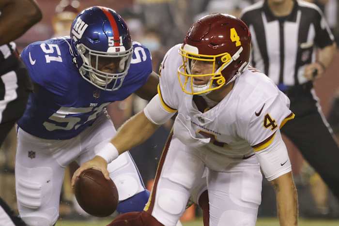 Washington quarterback Taylor Heinicke (4) is sacked by New York Giants linebacker Azeez Ojulari (51). Mandatory Credit: Geoff Burke-USA TODAY